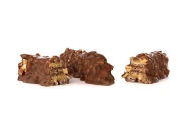 Chocolate bar on a white background. Candy with peanuts and raisins, caramel, puffed rice waffles, in chocolate isolated on white background.