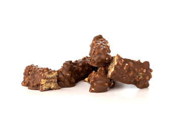 Chocolate bar on a white background. Candy with peanuts and raisins, caramel, puffed rice waffles, in chocolate isolated on white background.
