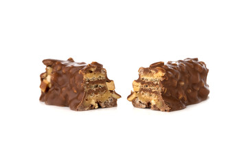 Chocolate bar on a white background. Candy with peanuts and raisins, caramel, puffed rice waffles, in chocolate isolated on white background.