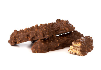 Chocolate bar on a white background. Candy with peanuts and raisins, caramel, puffed rice waffles, in chocolate isolated on white background.