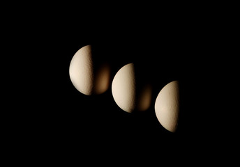 three eggs on black background