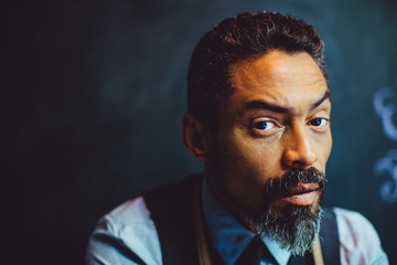 Close up portrait of a serious artist with beard looking