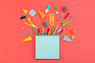 Creative flat lay with school supplies around blank notebook for copy space.. Top view.