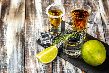 Set of strong alcoholic drinks in shot glass on rustic wood background. space for text. concept...