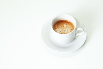 A cup of coffee on white table