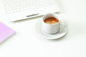 Coffee cup , laptop and lavender notpad on white table. Selective focus.