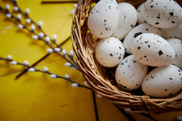 Fototapeta na wymiar Whole chicken eggs in brown wicker basket. The concept of Easter Holidays