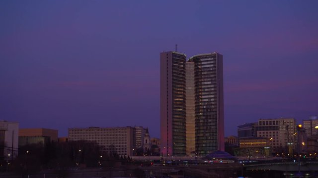 Panoramic overview of Moscow streets and Government House of the Russian Federation. Moscow. Passing cars, heavy traffic. Snow on the lawn. Winter. Sunset Orange and purple sky. Ultra HD stock footage