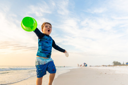 Young Boy Excited About Finding Sand Dollar on the Beach