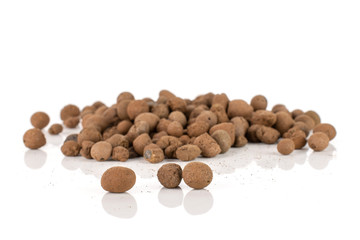 Lot of whole brown clay pebbles (leca) isolated on white background