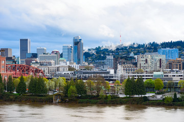 Fototapeta na wymiar Day view of Portland, Oregon downtown from Willamette river bank