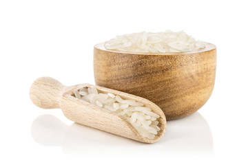 Lot of whole white jasmine rice grains in a wooden bowl isolated on white background