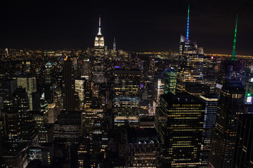 Fototapeta na wymiar Night time aerial view of Manhattan in New York City showing the classic high rise buildings and city scape in the USA