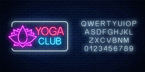 Fototapeta na wymiar Neon glowing sign of yoga exercices club with lotus symbol with alphabet. Street lights signboard of chinese gymnastics.