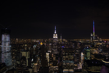 Fototapeta na wymiar Night time aerial view of Manhattan in New York City showing the classic high rise buildings and city scape in the USA