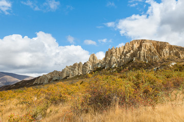 eroded clay cliffs with sharp pinnacles and deep ravines near Omarama, South Island, New Zealand