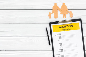 Children care with adoption application and family figure on white wooden background top view space...