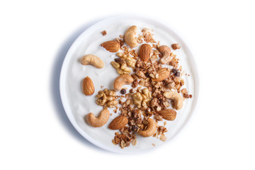 White plate with greek yogurt granola, almond, cashew, walnuts isolated on white background.