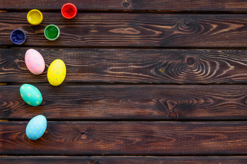eggs with colorful paint for easter tradition on wooden background top view mockup
