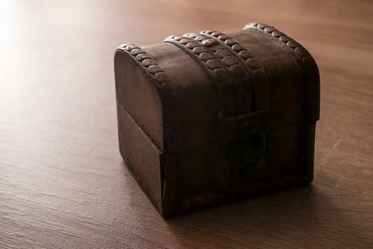 wooden treasure chest isolated on wooden background
