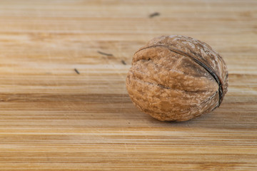 Single walnut on a wooden board