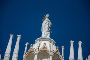 Fototapeta na wymiar Goddess of Justice old statue at the top of Doge Palace in Venice, Italy,2019,march