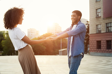 African-american couple having fun at sunset in the city
