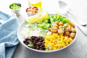 Chipotle spicy chicken lunch bowl with rice corn, beans, rice and jalapenos