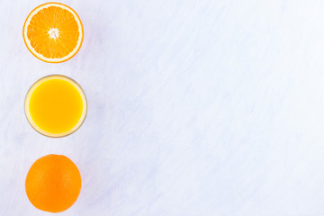 Orange fruits with juice, concept. Orange juice and halves of oranges on white background. Citrus...