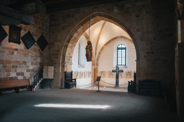 Catholic church interior with medieval walls and arch designed construction. Holy cross and gothic architecture