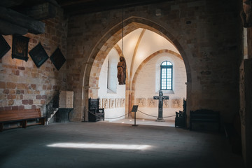 Obraz premium Catholic church interior with medieval walls and arch designed construction. Holy cross and gothic architecture