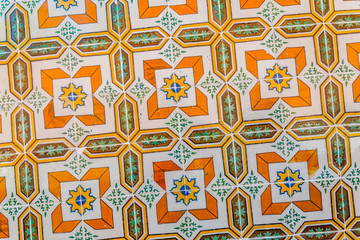 colored azulejo ceramic tiles in yellow, orange and green.