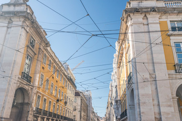 Tram power lines over a busy street.