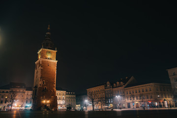 Obraz premium Town Hall Tower in Krakow, Poland. Night dusk shot of famous historic building