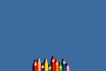 School pencils on a blue background isolated. Top view.