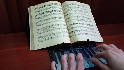 Search Photos Virtual Keyboard - 0 28 the man plays the virtual piano keyboard on notes close up