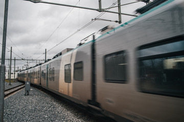 Naklejka premium Blurred train motion with high speed at railway station