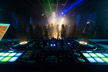 Fototapeta na wymiar professional DJ mixer controller for mixing music in a nightclub
