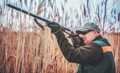 Fototapeta premium Hunter with a rifle in hunting