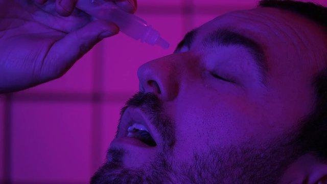 Gamer Programmer Hacker Pouring Medicine Drops In His Eyes