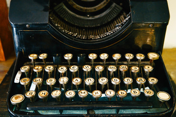 Old damaged typewriter on table