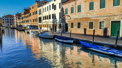 Fototapeta na wymiar old buildings and boats on canal in Venice, Italy,2019