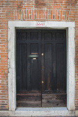 Fototapeta na wymiar The door of an venetian house,Italy,Venetia,Venice,2019