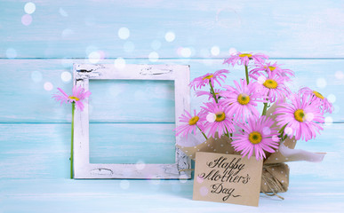 Chamomile, vintage photo frame in Shabby Chic style and greeting card for Mother's day on wooden wall background