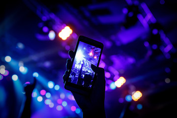 Filming a concert on mobile phone camera, stage blue light