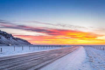 Winter sunrise on Hringvegur in Iceland. Route 1 or the Ring Road or Hringvegur is a national road in Iceland that runs around the island and connects most of the inhabited parts of the country.