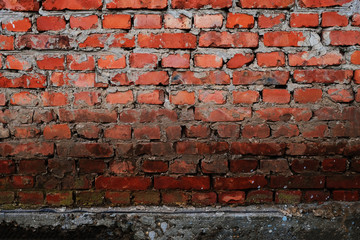 Fototapeta premium Brick wall of an old house. Texture of a brickwall of an old building. Brickwork close-up. Architectural vintage masonry