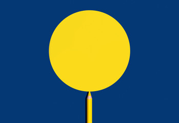 Yellow pencil draw yellow circle shape for copy space on a blue background. 