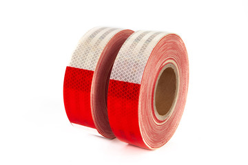 Adhesive tape with reflective effect. Red white ribbon with a reflector. Security.