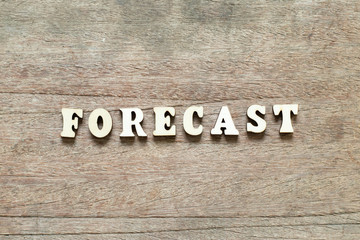 Letter block in word forecast on wood background